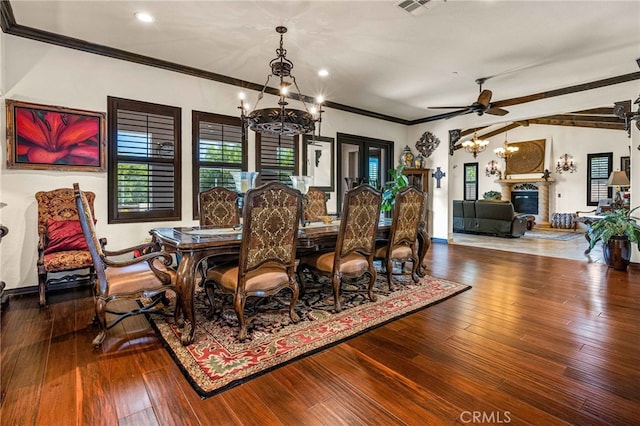 dining space with hardwood / wood-style flooring, ceiling fan with notable chandelier, baseboards, and ornamental molding