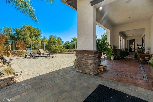 view of patio / terrace featuring fence