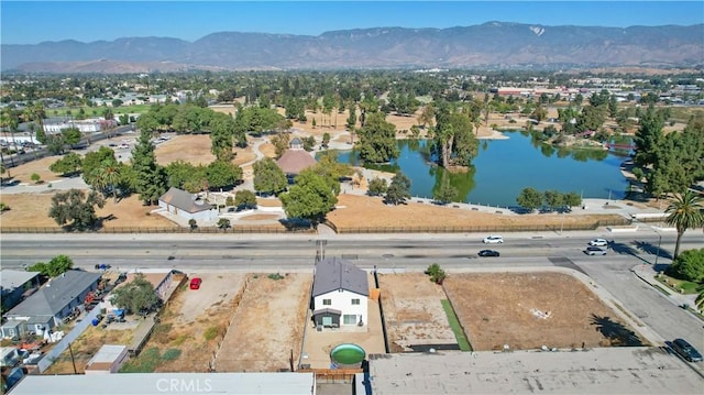 birds eye view of property featuring a water and mountain view