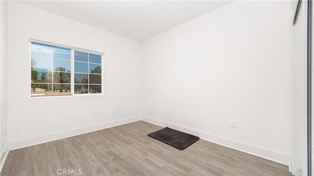 empty room with hardwood / wood-style flooring