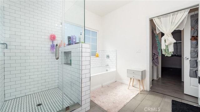 bathroom with independent shower and bath and tile patterned floors