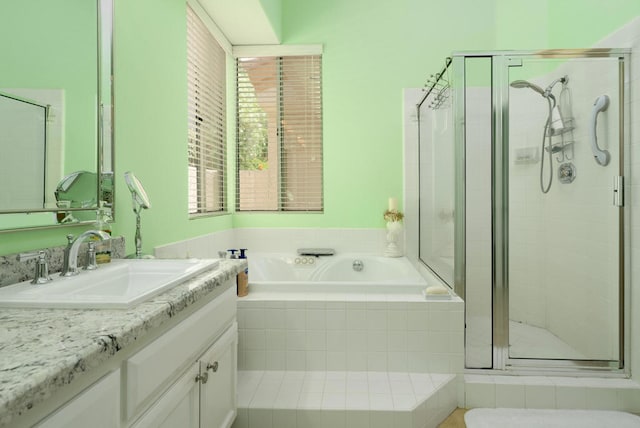 bathroom with vanity and independent shower and bath