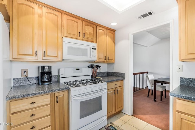 kitchen with light brown cabinets, white appliances, and light carpet