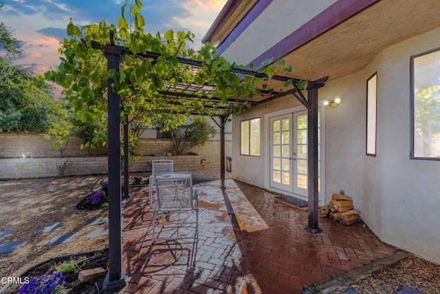 patio terrace at dusk with a pergola and french doors