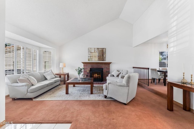 carpeted living room featuring a fireplace and high vaulted ceiling