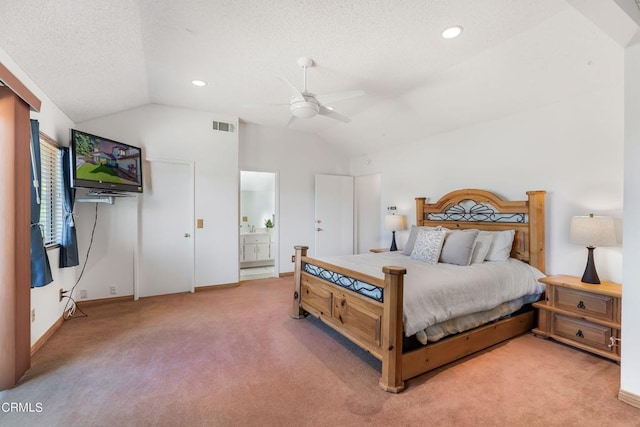 carpeted bedroom with ceiling fan, connected bathroom, and vaulted ceiling