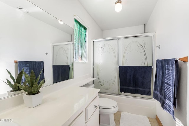 full bathroom featuring tile patterned floors, vanity, bath / shower combo with glass door, and toilet