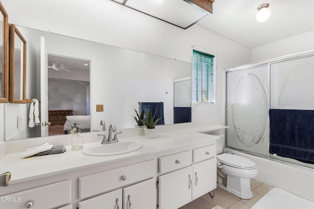 full bathroom with tile patterned floors, vanity, ceiling fan, shower / bath combination with glass door, and toilet