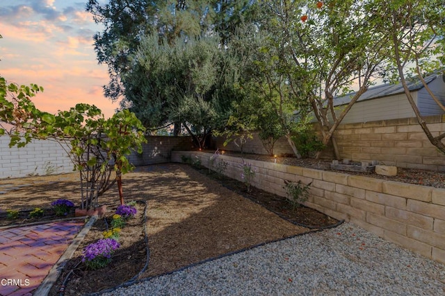 yard at dusk with a patio area