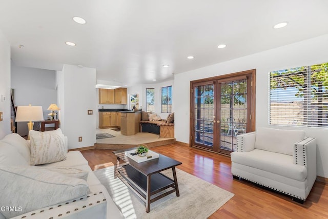 living room featuring french doors and light hardwood / wood-style flooring