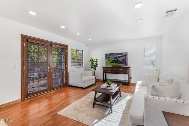 living room featuring french doors and hardwood / wood-style flooring