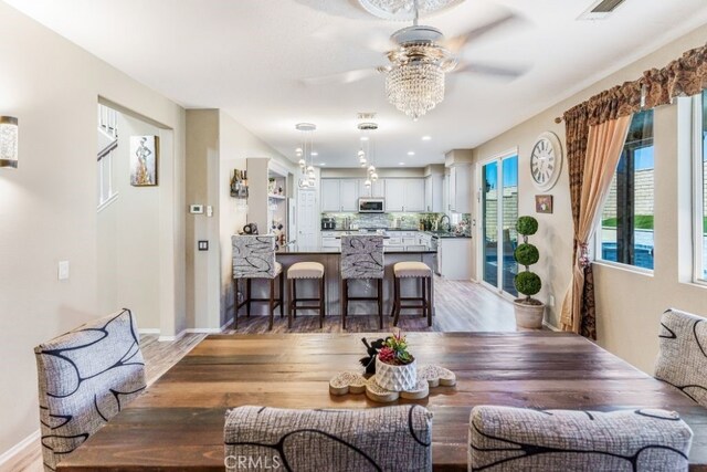 dining room with ceiling fan and dark hardwood / wood-style flooring