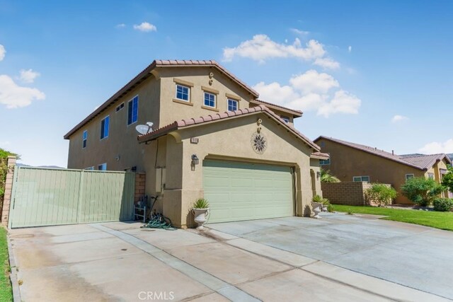 mediterranean / spanish home with a garage