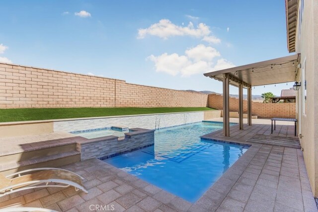 view of swimming pool featuring an in ground hot tub and a patio area