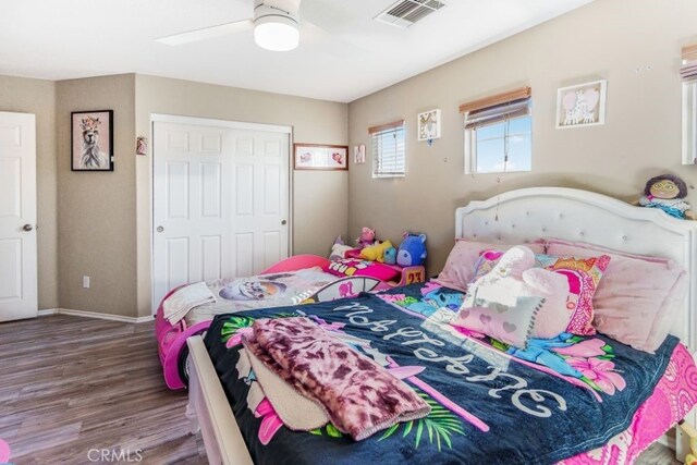 bedroom featuring a closet, hardwood / wood-style floors, and ceiling fan