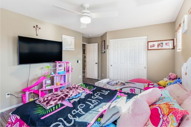 bedroom with a closet, wood-type flooring, and ceiling fan