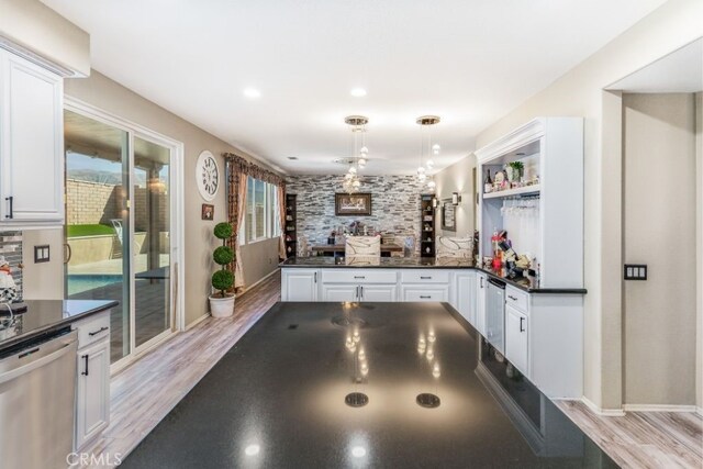 kitchen featuring dishwasher, white cabinetry, light hardwood / wood-style flooring, and pendant lighting