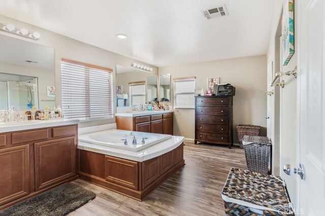 bathroom with vanity, a bathtub, and hardwood / wood-style flooring