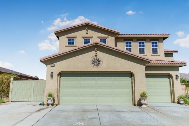 mediterranean / spanish-style home with a garage