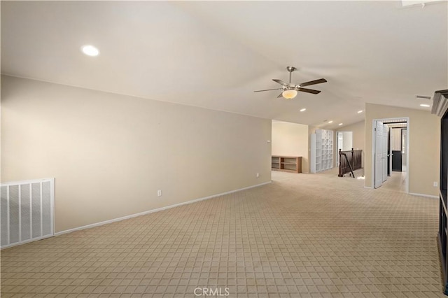 carpeted spare room featuring ceiling fan and lofted ceiling