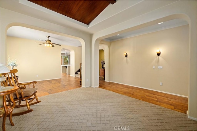 interior space with ceiling fan, light hardwood / wood-style floors, and crown molding