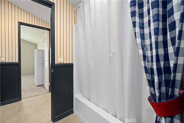 bathroom featuring tile patterned flooring and shower / bath combination with curtain