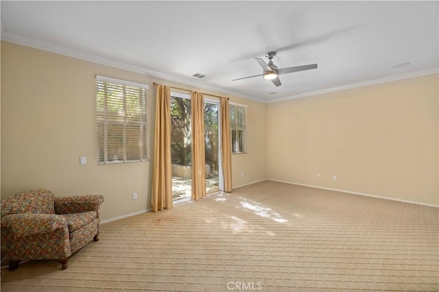 sitting room featuring light colored carpet, ceiling fan, and crown molding