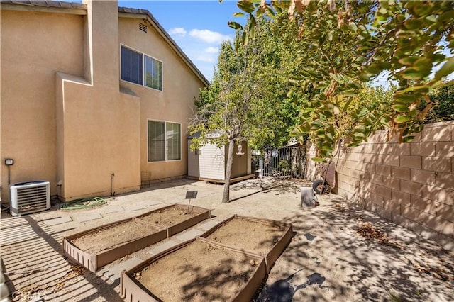 back of property with a shed and central AC unit