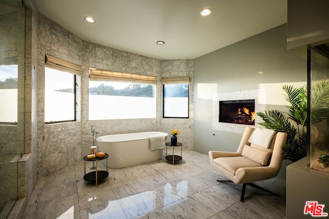 bathroom with tile walls and a washtub