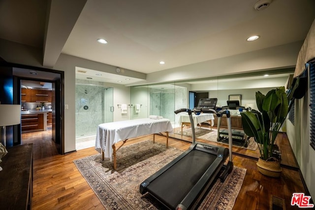 exercise room featuring hardwood / wood-style floors