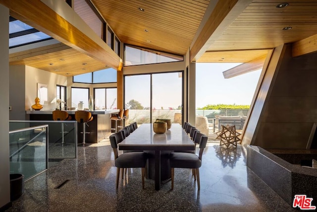 dining room featuring beamed ceiling, a healthy amount of sunlight, wood ceiling, and high vaulted ceiling