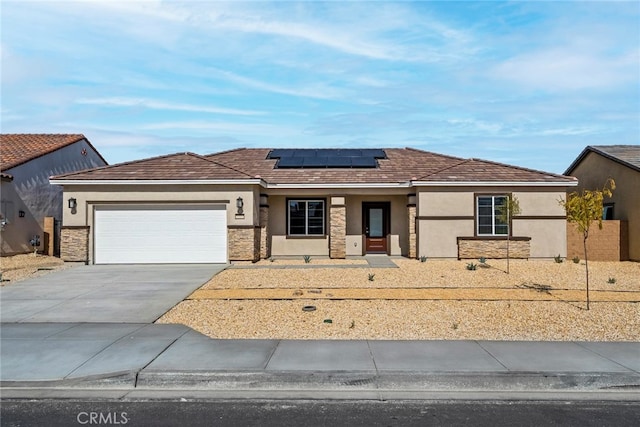 view of front of home with solar panels and a garage