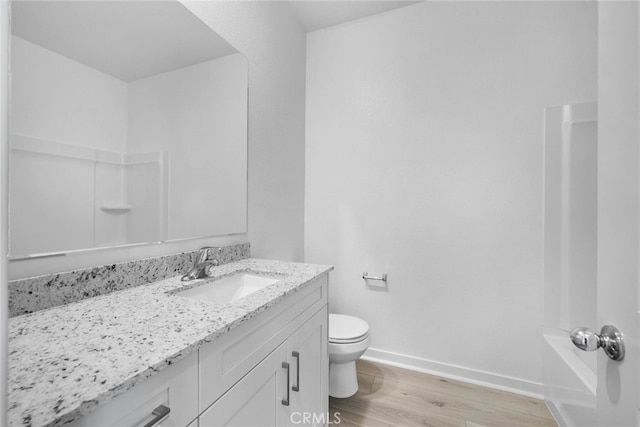 full bathroom featuring vanity, toilet, wood-type flooring, and shower / washtub combination