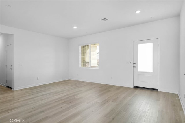 unfurnished room with light hardwood / wood-style flooring