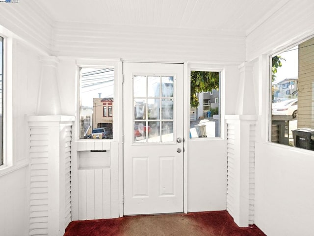 doorway featuring dark colored carpet