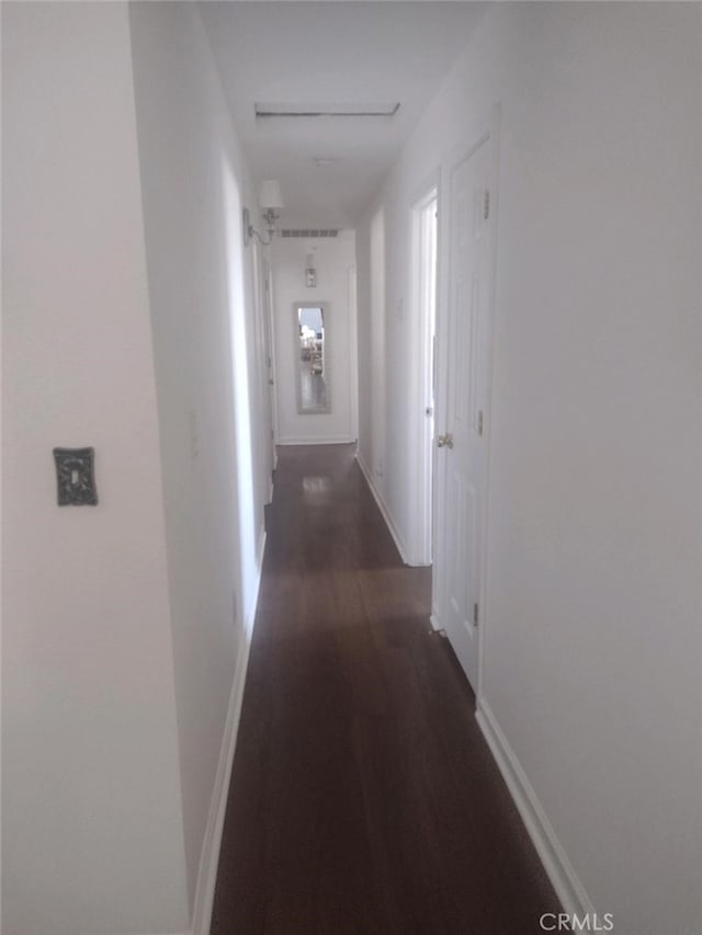 corridor with dark wood-type flooring