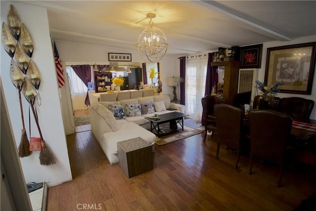 living room with beam ceiling, hardwood / wood-style floors, and an inviting chandelier