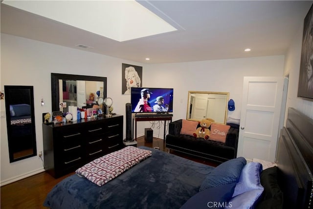 bedroom with dark hardwood / wood-style flooring