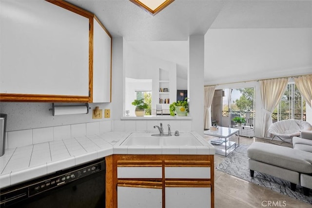 kitchen with dishwasher, sink, tile countertops, and white cabinetry