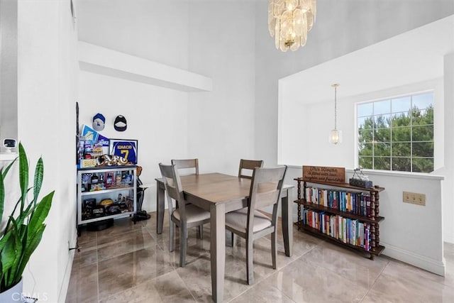 dining area featuring a high ceiling and a chandelier