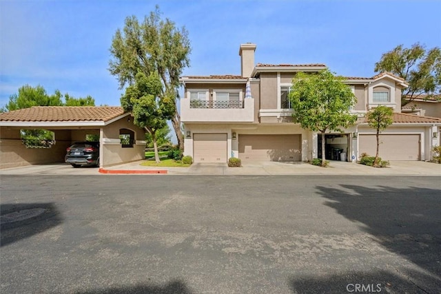 view of front of property featuring a balcony and a carport