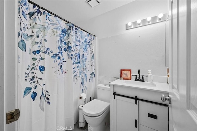 bathroom featuring toilet, vanity, and a shower with curtain