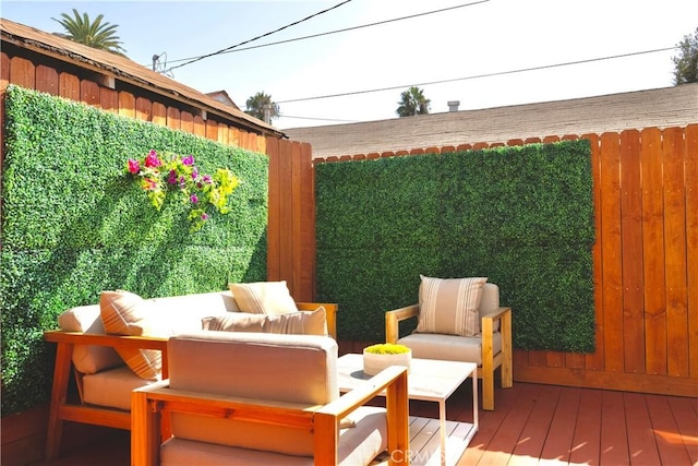 exterior space with an outdoor hangout area and fence