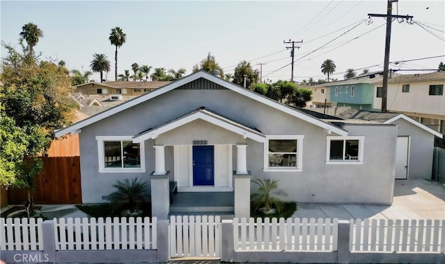 view of front of house featuring a fenced front yard and stucco siding