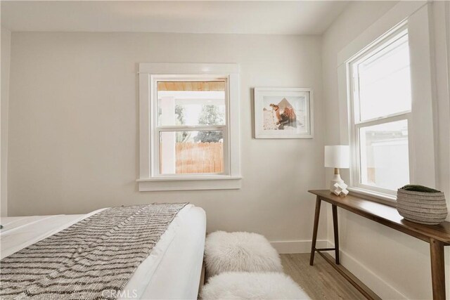 bedroom with wood finished floors and baseboards