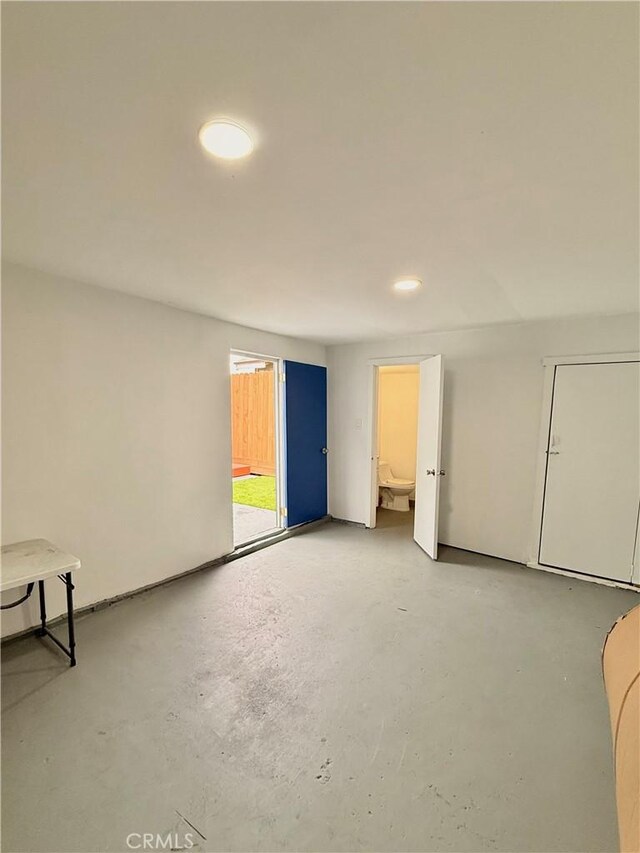 unfurnished bedroom featuring concrete floors