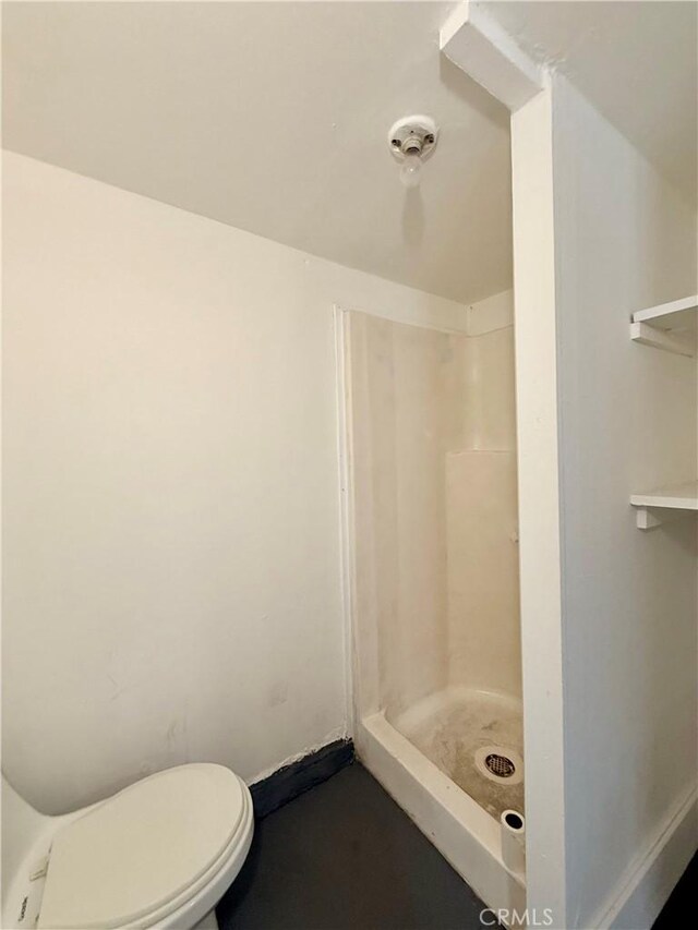 bathroom with toilet and a stall shower