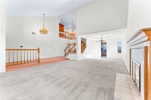 17931 Calle, Los Arboles, Rowland Heights, CA 91748 - unfurnished living room featuring light colored carpet, a towering ceiling, visible vents, stairway, and a chandelier
