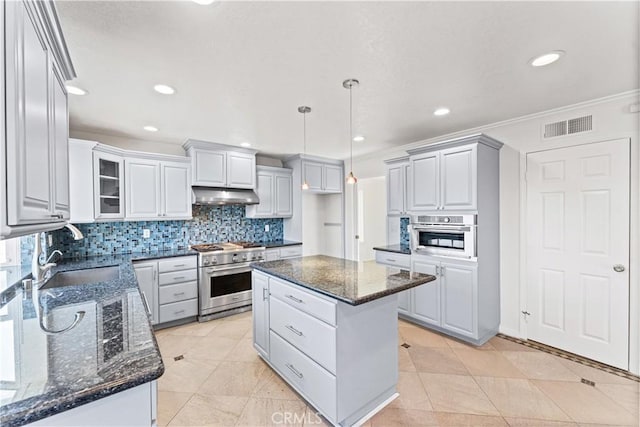 17931 Calle, Los Arboles, Rowland Heights, CA 91748 - kitchen with visible vents, appliances with stainless steel finishes, under cabinet range hood, a sink, and decorative backsplash