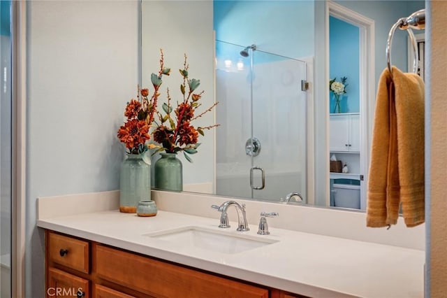 bathroom with an enclosed shower and vanity